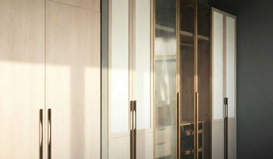 Wardrobe wall with light wood shutters and fluted glass doors in evening light
